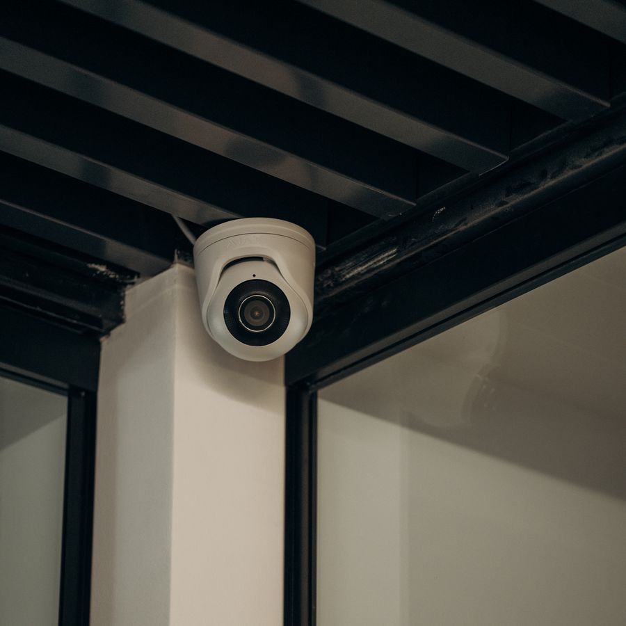 Dome security camera installed at a ceiling corner